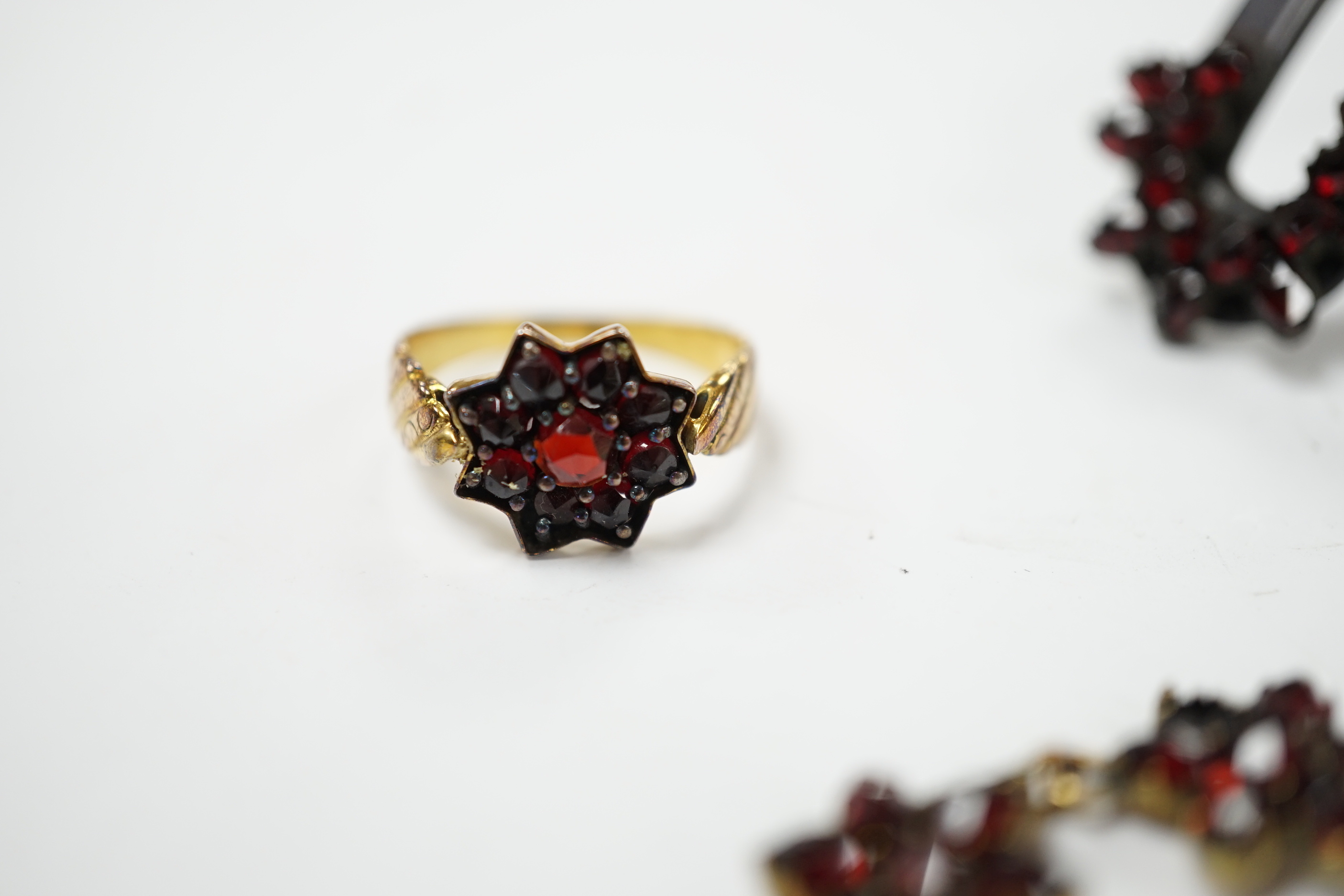 A Victorian garnet set gilt metal and tortoiseshell suite of jewellery comprising bracelet, necklace, ring and two hair combs